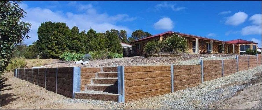 A finished concrete sleeper retaining wall in Nerang