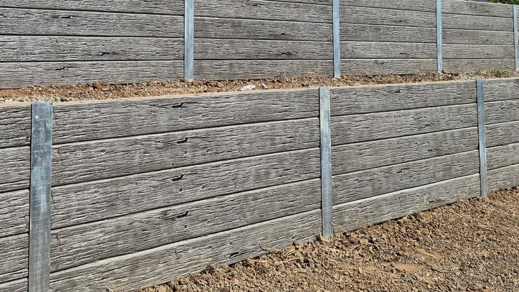 The face of a timber grain concrete sleeper wall, close